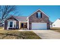 Charming brick home features a two-car garage, bay window, and well-maintained front yard at 2228 Silver Rose Dr, Avon, IN 46123