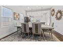 Elegant dining area featuring modern lighting and an open layout to the kitchen at 234 N State Ave, Indianapolis, IN 46201