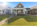 Charming two-story home featuring a well-maintained lawn and inviting front porch at 234 N State Ave, Indianapolis, IN 46201
