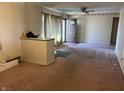 Spacious living room featuring neutral-colored walls, carpeted floor, and large window at 338 A St, Wilkinson, IN 46186