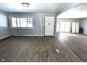Living space featuring neutral paint, new floors, and a white front door at 401 W Edwards Ave, Indianapolis, IN 46217