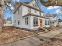 Charming two-story home with an orange door, set amidst a picturesque neighborhood at 422 E Main St, Lebanon, IN 46052