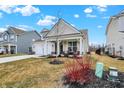 Exterior view of house featuring a covered front porch with chairs and tidy landscaping at 4425 Maize Ln, Whitestown, IN 46075