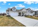 View of the house with a large driveway and well-maintained lawn in a residential neighborhood at 4425 Maize Ln, Whitestown, IN 46075