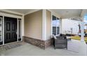 Inviting front porch with seating area, brick accents, and a view of the well-kept yard at 4425 Maize Ln, Whitestown, IN 46075