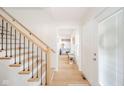Bright foyer showcasing a staircase with iron spindles and a view into a comfortably furnished sitting room at 4981 E County Road 200 S, Avon, IN 46123