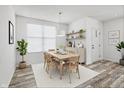 Bright dining room with natural light, a wood table and chairs, decor, and stylish flooring at 5648 Juniper Ct, Whitestown, IN 46075