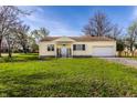 Lovely one-story home boasting an attached garage and a vibrant green lawn at 5757 E 21St St, Indianapolis, IN 46218