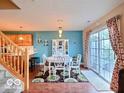 Bright dining room featuring a sliding glass door, stylish decor, and hardwood floors at 5944 Streamwood Ln, Indianapolis, IN 46237