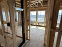 Framed living room showcasing the construction phase, with window framing providing natural light and views of the surrounding landscape at 618 Firefly Ct, Greenfield, IN 46140