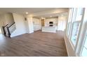 Bright and airy living room featuring hardwood floors and large windows allowing ample natural light at 6895 Seabiscuit Rd, Whitestown, IN 46075