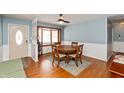 Charming dining area with a bay window, traditional table set, and a decorative front door entrance enhancing the cozy ambiance at 6907 Buick Dr, Indianapolis, IN 46214