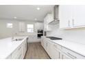 Beautiful white kitchen featuring stainless steel appliances, subway tile backsplash and center island at 7038 Barrett Dr, Brownsburg, IN 46112