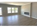 Spacious living room showcasing hardwood floors, a modern fireplace, and large windows at 750 Oakleaf Dr, Greenfield, IN 46140