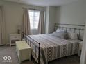 Comfortable bedroom with a metal frame bed, neutral decor, carpet, and natural light at 8148 Shores Edge Way, Indianapolis, IN 46237