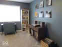 Stylish room featuring cool toned walls, a desk by a bright window, and modern shelving at 8148 Shores Edge Way, Indianapolis, IN 46237