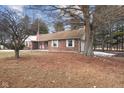 Exterior view of a brick home with well-maintained front yard and charming appeal at 11131 N State Road 9, Fountaintown, IN 46130