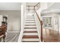 Well-lit foyer with hardwood floors and a staircase leading to the upper level, complemented by neutral walls at 14085 Honey Tree Dr, Carmel, IN 46032