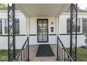 Inviting front porch, with decorative railing, black iron security door, and a neatly maintained entrance at 1467 N Euclid Ave, Indianapolis, IN 46201