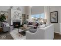 Bright living room features a fireplace, tall windows with natural light and modern furniture at 19763 Atwater Ave, Sheridan, IN 46069