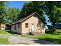 Cozy home with a white back door, complimented by well-maintained siding and a paved driveway at 210 S West St, Paragon, IN 46166