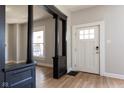 Welcoming foyer with striking dark wood accents, neutral walls and a bright white door at 2162 Ringgold Ave, Indianapolis, IN 46203