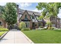 Beautiful brick home featuring a long driveway and an inviting front lawn at 219 Buckingham Dr, Indianapolis, IN 46208