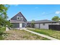 Spacious backyard features a well-defined walkway, fence, and potential for landscaping at 2257 E Brookside Ave, Indianapolis, IN 46218