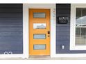 Close-up of the front door featuring sidelights, modern design, and new hardware at 2257 E Brookside Ave, Indianapolis, IN 46218