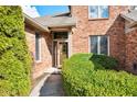 Inviting front entrance with a decorative glass door and manicured shrubbery at 2487 Wayward Wind Dr, Indianapolis, IN 46239