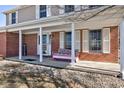 Inviting front porch featuring a cozy bench, welcome sign, and classic brick accents at 3492 S 600 W, Anderson, IN 46011