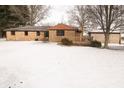 Backyard featuring a deck, with a full brick house and a snowy lawn at 3850 N County Road 575 E, Brownsburg, IN 46112