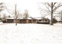 Charming brick home with attached garage and well-maintained landscaping, nestled in a snow-covered lot at 3850 N County Road 575 E, Brownsburg, IN 46112