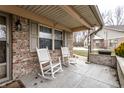 Welcoming front porch featuring classic rocking chairs, brick facade, and a peaceful spot for relaxing at 4033 Oak Trail Dr, Indianapolis, IN 46237