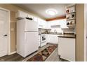 Bright kitchen with white cabinets, laminate countertops, and modern appliances at 4033 Oak Trail Dr, Indianapolis, IN 46237