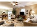 Comfortable living room with hardwood floors, ceiling fan, and a view into the dining area at 4033 Oak Trail Dr, Indianapolis, IN 46237
