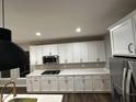 Spacious kitchen featuring white cabinetry, granite countertops, and stainless steel appliances at 4187 Risen Star Way, Bargersville, IN 46106