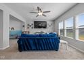 Cozy living room with vaulted ceilings, a large window, and a comfortable blue sofa at 4345 Indigo Walk Ln, Indianapolis, IN 46239