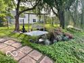 Picturesque backyard with a serene swing under a tree, complemented by beautiful landscaping and a peaceful ambiance at 520 Gatewood Dr, Greenwood, IN 46143