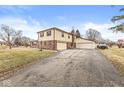 The two-car attached garage and additional garage are connected by a long driveway, adding to the charm of the house at 5465 Leone Dr, Indianapolis, IN 46226