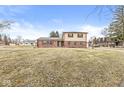 Charming two-story home featuring brick and siding with red shutters and a well-maintained front yard at 5465 Leone Dr, Indianapolis, IN 46226