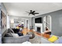 Cozy living room with hardwood floors, a fireplace, and an adjacent dining area, with stairs to the right at 5860 Indianola Ave, Indianapolis, IN 46220
