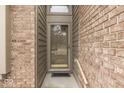 Close-up of a charming front door, complemented by a brick wall and modern sidelights at 613 Brook Dr, Greenwood, IN 46143