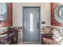 Inviting entryway showcasing a gray front door, stone accents, and wood trim for a warm welcome at 6420 Oriole Dr, Nineveh, IN 46164