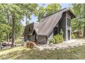 Stylish A-frame home with gray shingles, brick accents, and a landscaped yard extending to the waterfront at 6420 Oriole Dr, Nineveh, IN 46164