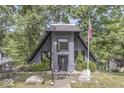 Unique A-frame home featuring gray brick and siding, symmetrical landscaping, and a well-maintained lawn at 6420 Oriole Dr, Nineveh, IN 46164