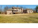 Large backyard view of house with wooden deck and screened in porch on a sprawling green lawn at 8221 Mcwhorter Rd, Martinsville, IN 46151