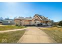 A house and detached garage on a large lot with a long driveway and blue skies above at 8221 Mcwhorter Rd, Martinsville, IN 46151