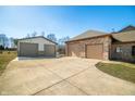 Spacious detached garage and attached garage with concrete driveway, perfect for car enthusiasts or extra storage at 8221 Mcwhorter Rd, Martinsville, IN 46151