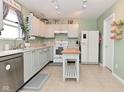 Functional kitchen featuring white appliances, center island, and a window for natural light at 8317 S Swimming Hole Ln, Pendleton, IN 46064